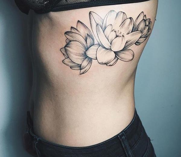 An alluring lotus tattoo design on side rib for Women