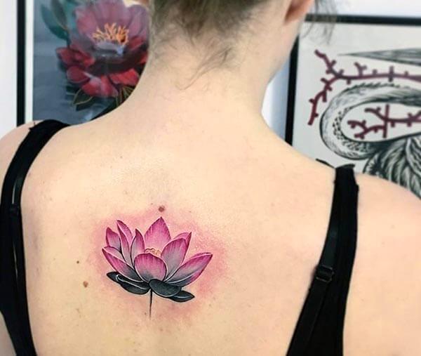 A heartwarming lotus tattoo design on back for women