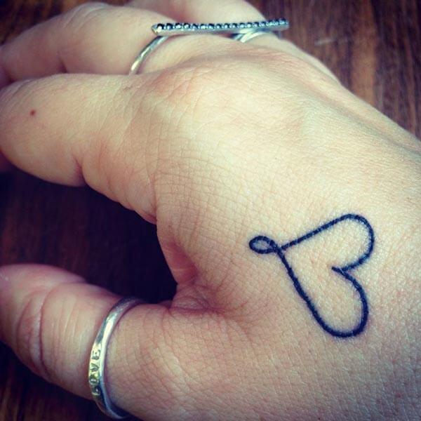 A pretty love tattoo design on hand for girls