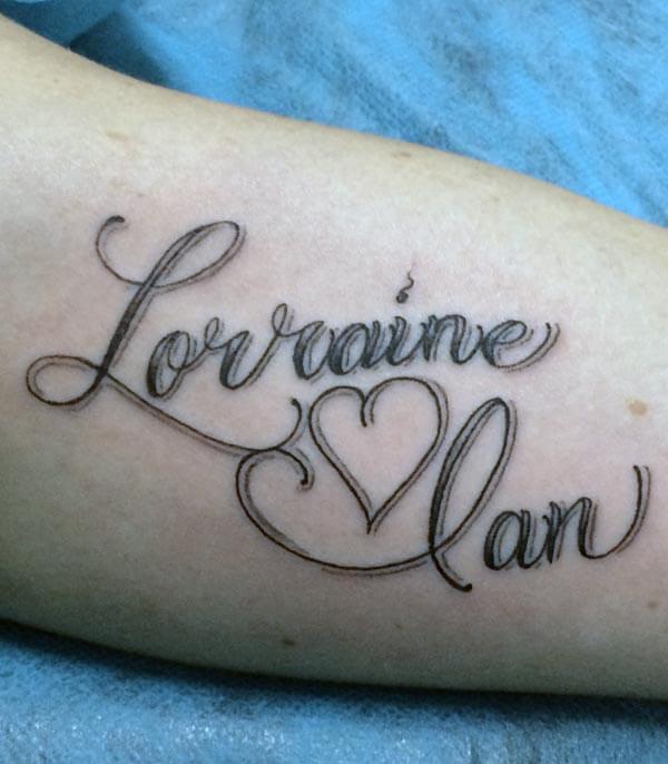 A lovely love tattoo design on forearm for ladies