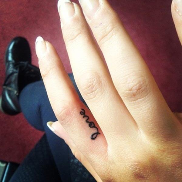 A cute love tattoo design on finger side for women