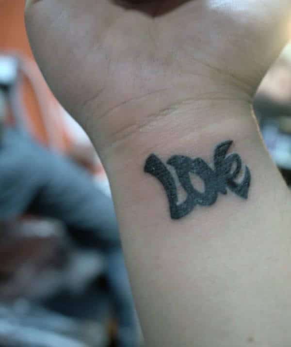 A delightful love tattoo design on wrist for Ladies
