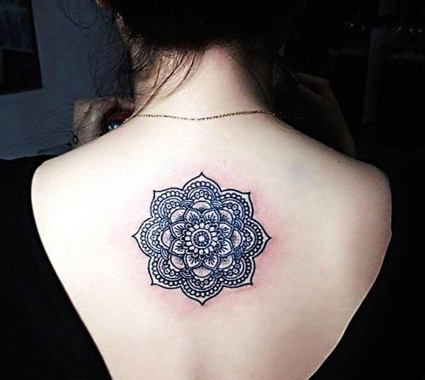 An aesthetic mandala tattoo design on back for ladies