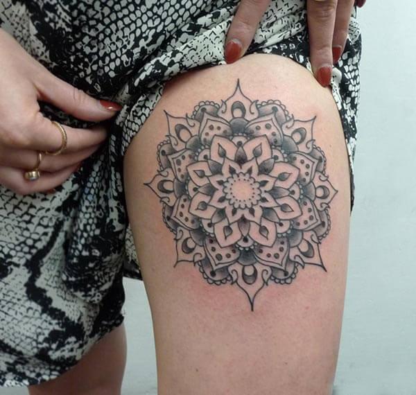 A graceful mandala tattoo design on thigh for girls and women