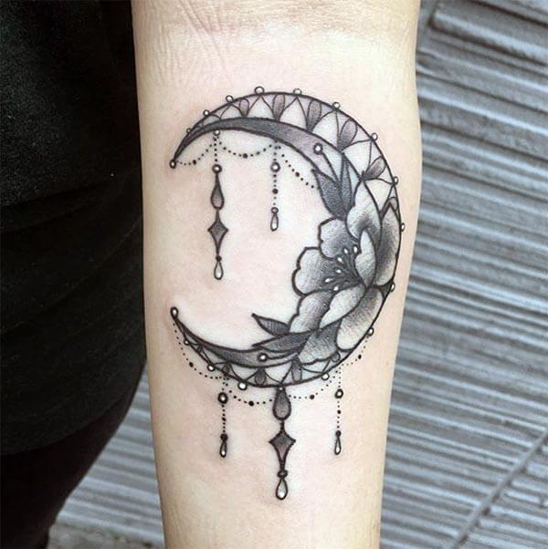 An appealing moon tattoo design on forearm for Women and girls