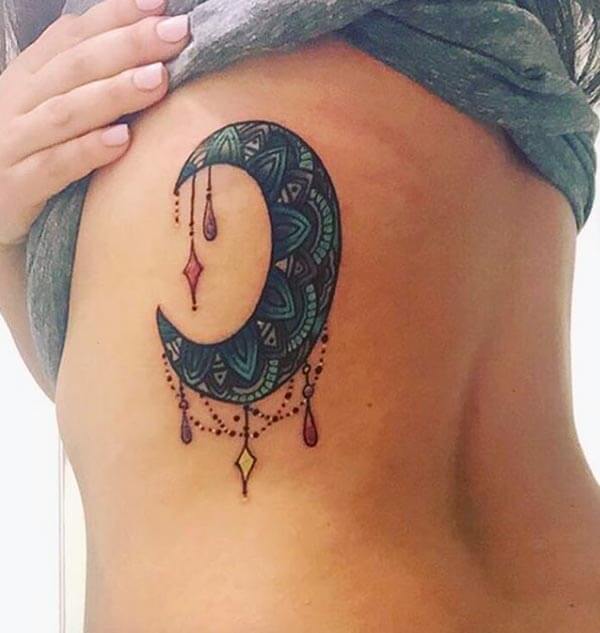 A jaw-dropping moon tattoo design on side belly for Ladies