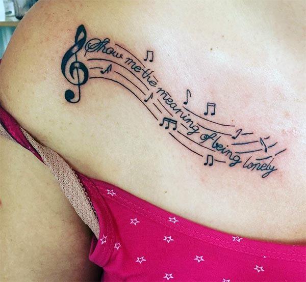 A lovely music tattoo design on back for Girls and women