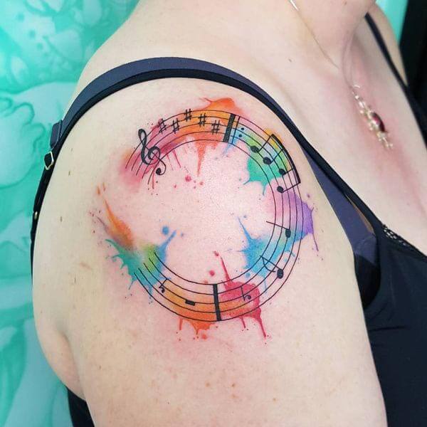 An enchanting music tattoo design on shoulder of Ladies