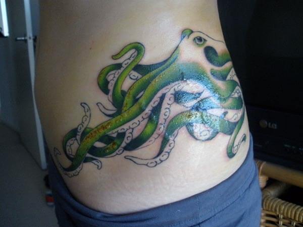 A cool octopus tattoo design on side belly for women