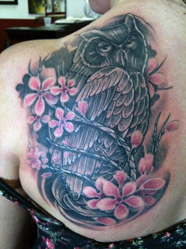 A captivating owl tattoo design on back shoulder for Girls