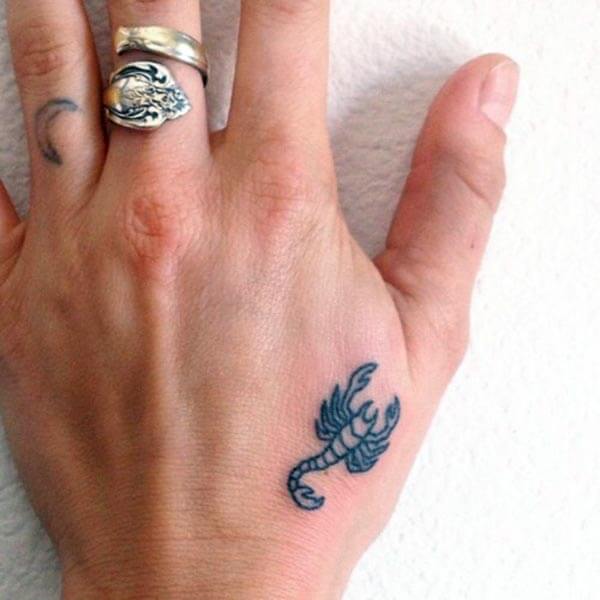 A cute little scorpion tattoo design on back palm for girls