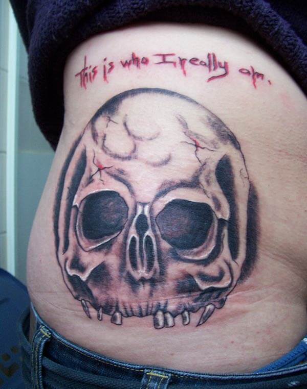 A cool skull tattoo design on side belly for Women