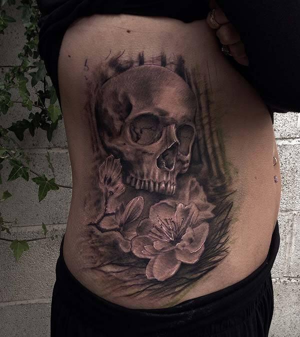 An exquisite skull tattoo design on side belly for girls