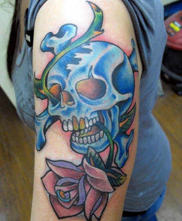 An awesome skull tattoo design on upper arm for women