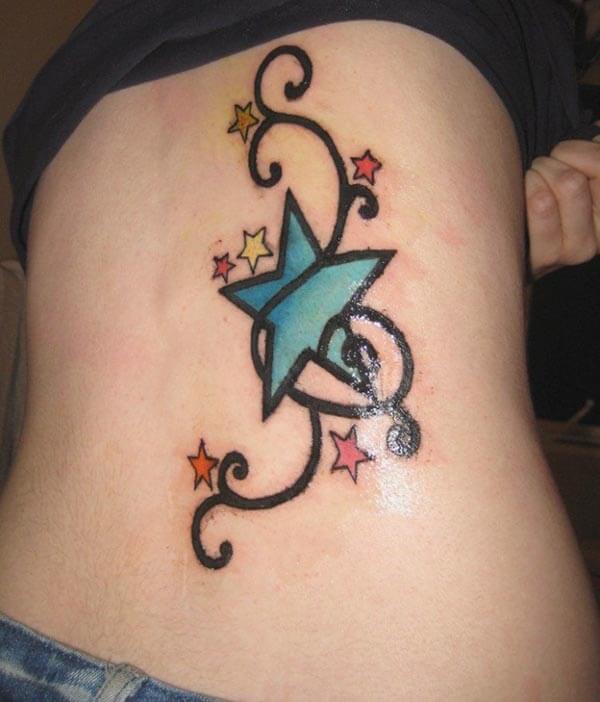 An attractive star tattoo design on lower back for Ladies and women