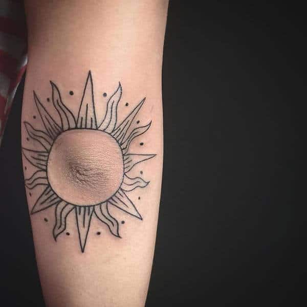 A delightful sun tattoo design on elbow for Women