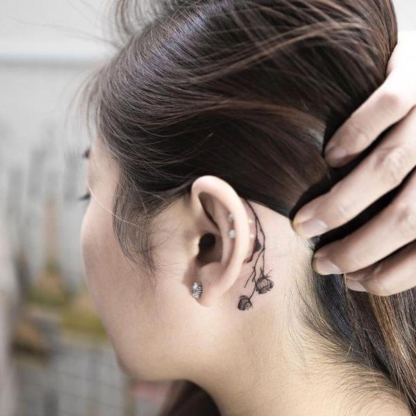 A heavenly behind the ear tattoo design for girls and women