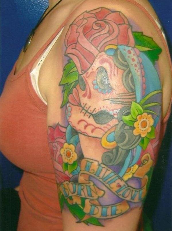 A vibrant day of the dead tattoo design on shoulder for girls