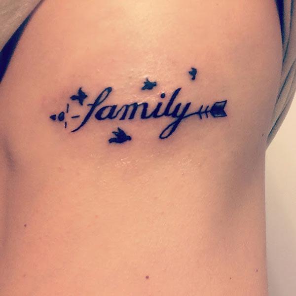 A simple cute family tattoo design on side belly for women