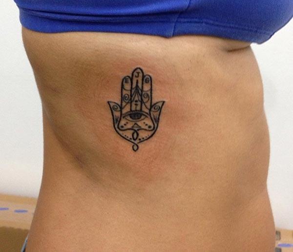 A lovely Hamsa tattoo design on side belly for ladies