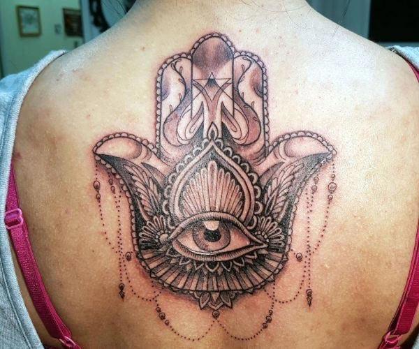 An enchanting Hamsa tattoo design on back for ladies