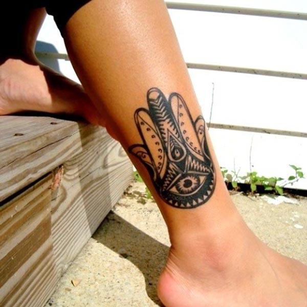 A bold Hamsa tattoo design on side calf for girls and women
