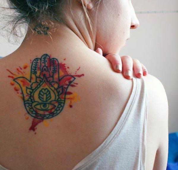 A vibrant hamsa tattoo design on back for girls