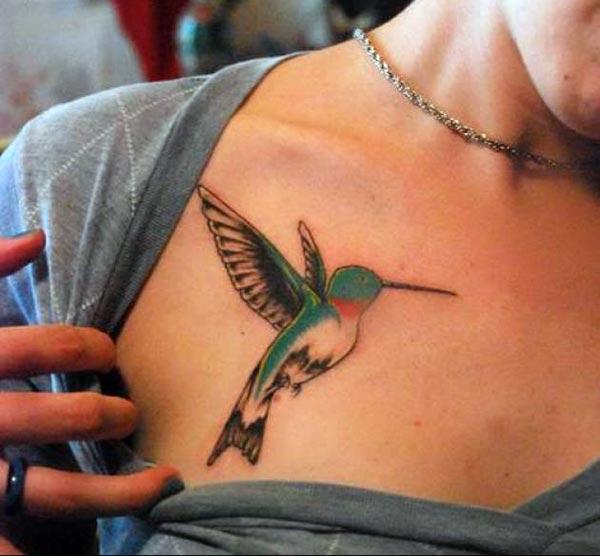A striking hummingbird tattoo design on front chest for girls