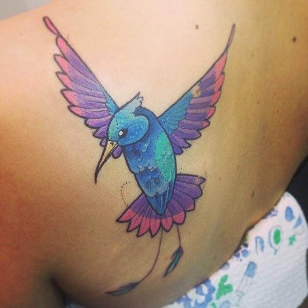 A magical hummingbird tattoo design on back shoulder for Girls