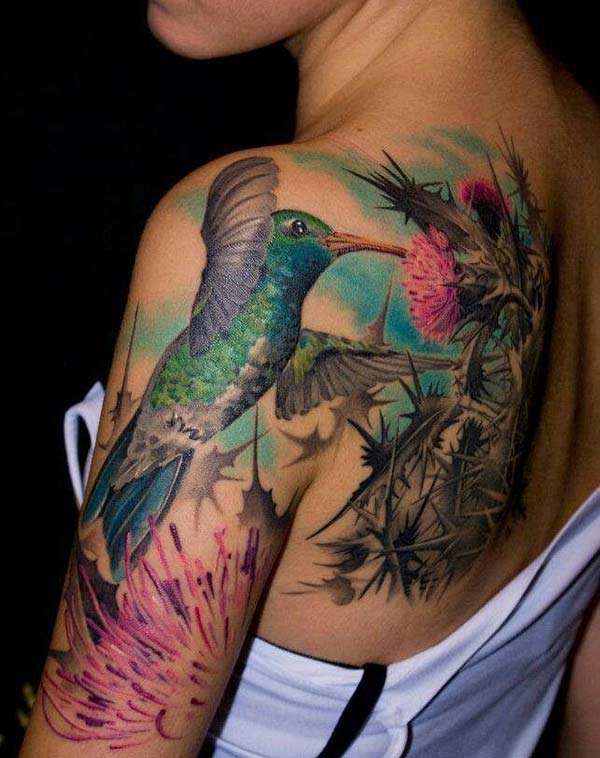 An aesthetic hummingbird tattoo design on side shoulder for ladies
