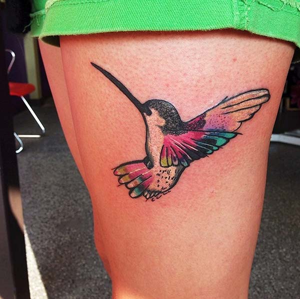 A cute little hummingbird tattoo design on thigh for women
