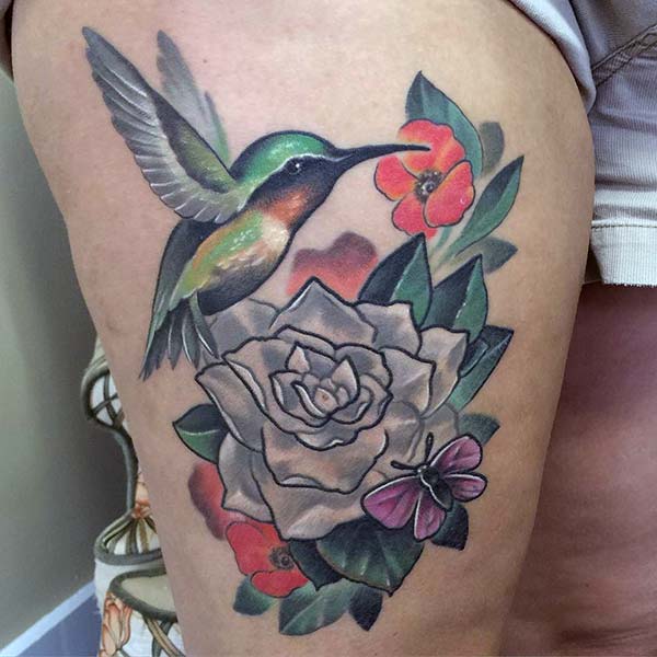 A gorgeous hummingbird tattoo design on thigh for ladies