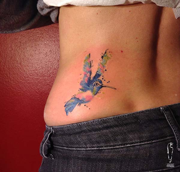 An enchanting hummingbird tattoo design on side belly for girls