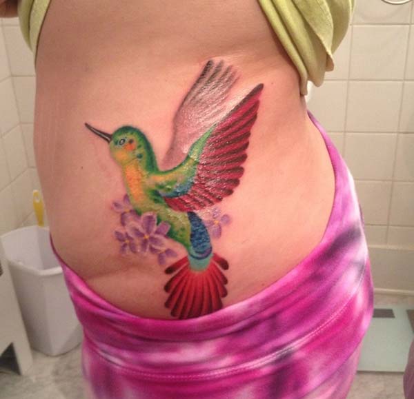 An irresistible hummingbird tattoo design on side belly for Women