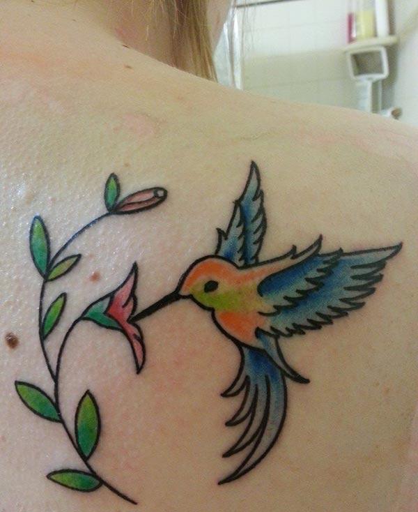 A graceful hummingbird tattoo design on back shoulder for women