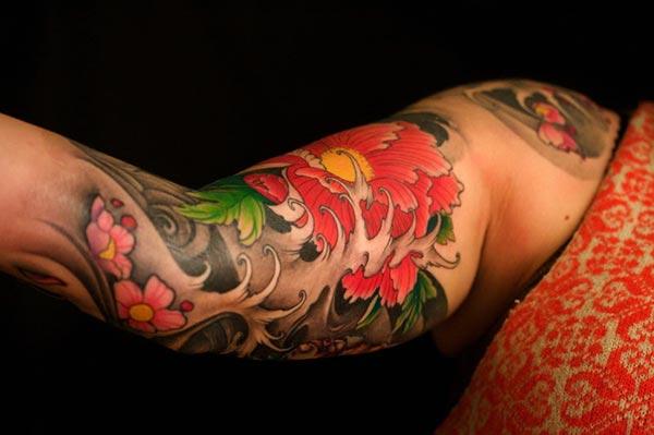 A colorful Japanese tattoo design on forearm for ladies