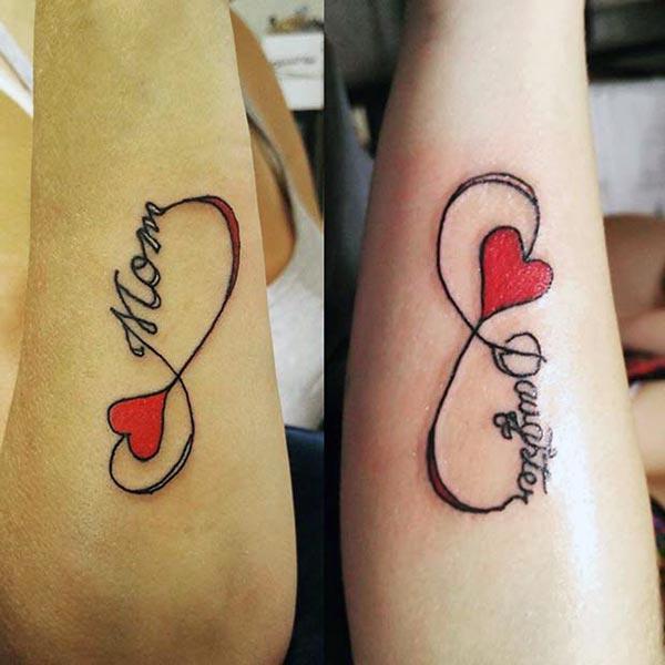 An enchanting mother-daughter tattoo design on forearm