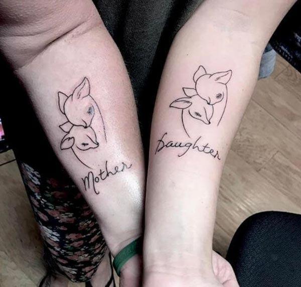 A heartwarming mother-daughter tattoo design on forearm