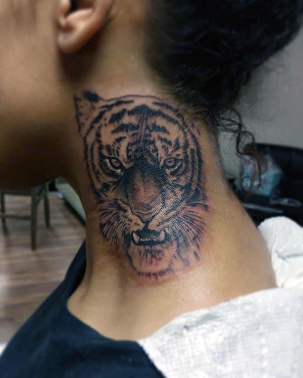 A ferocious tiger tattoo design on neck for girls and ladies
