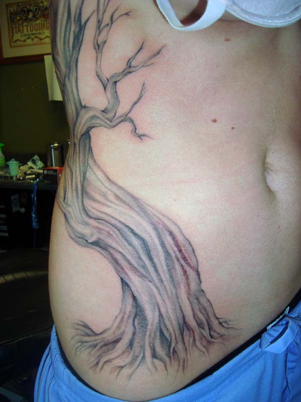 A captivating tree tattoo design on side belly for girls