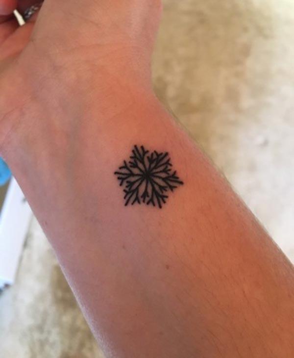 A tiny charming wrist tattoo design for girls